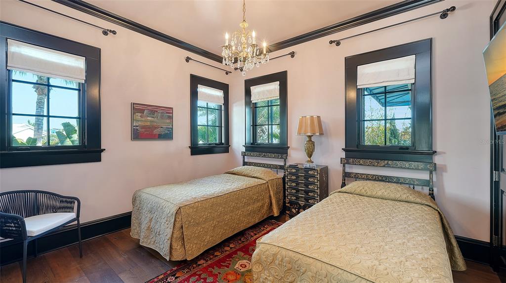 513 Villa Rosa Way Anna Maria, FL 34216 - Photo 20 of 57 a bedroom with two beds and a window