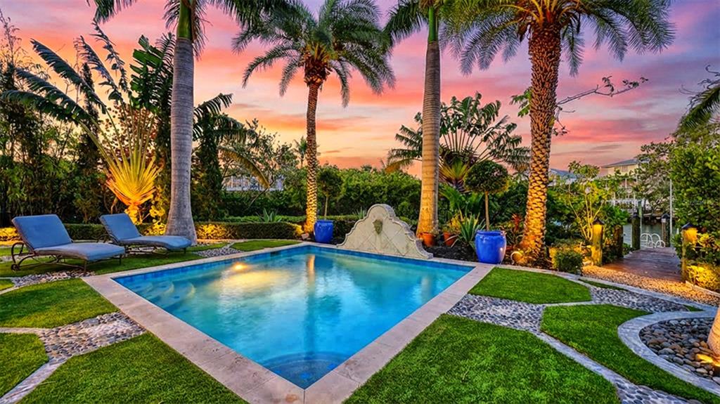 513 Villa Rosa Way Anna Maria, FL 34216 - Photo 2 of 57 a view of a backyard with swimming pool