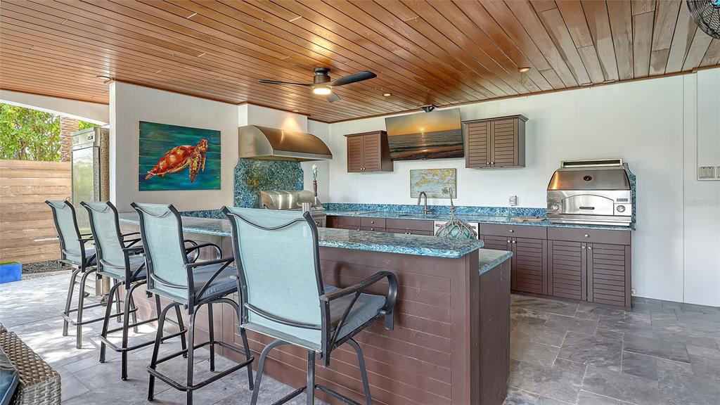 513 Villa Rosa Way Anna Maria, FL 34216 - Photo 32 of 57 a dining room with furniture and wooden floor