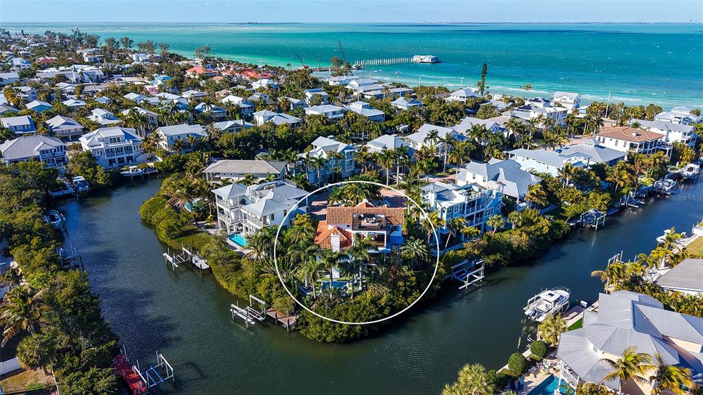 513 Villa Rosa Way Anna Maria, FL 34216 - Photo 33 of 57 an aerial view of a house with a lake view
