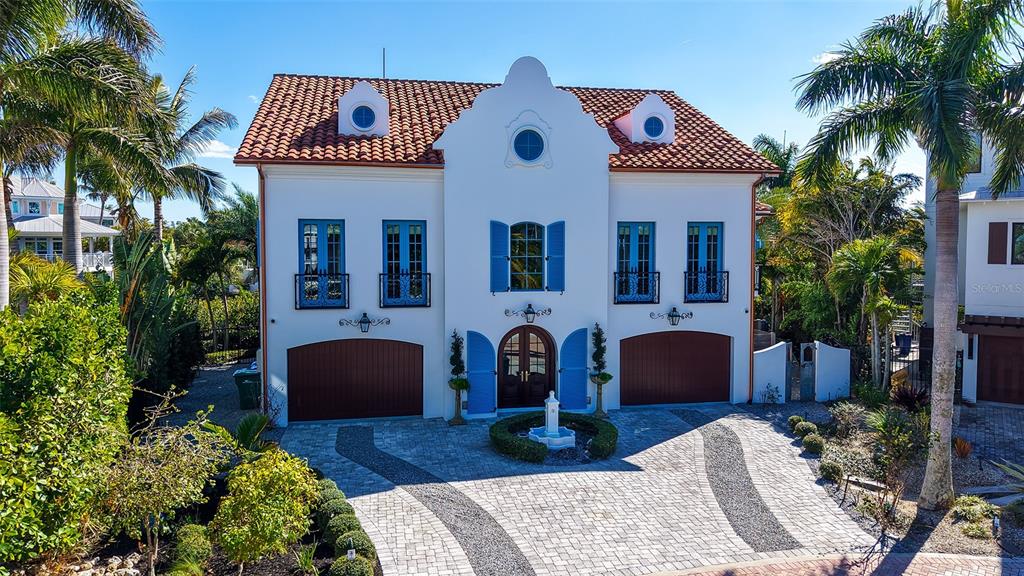 513 Villa Rosa Way Anna Maria, FL 34216 - Photo 46 of 57 a front view of a house with garden and furniture