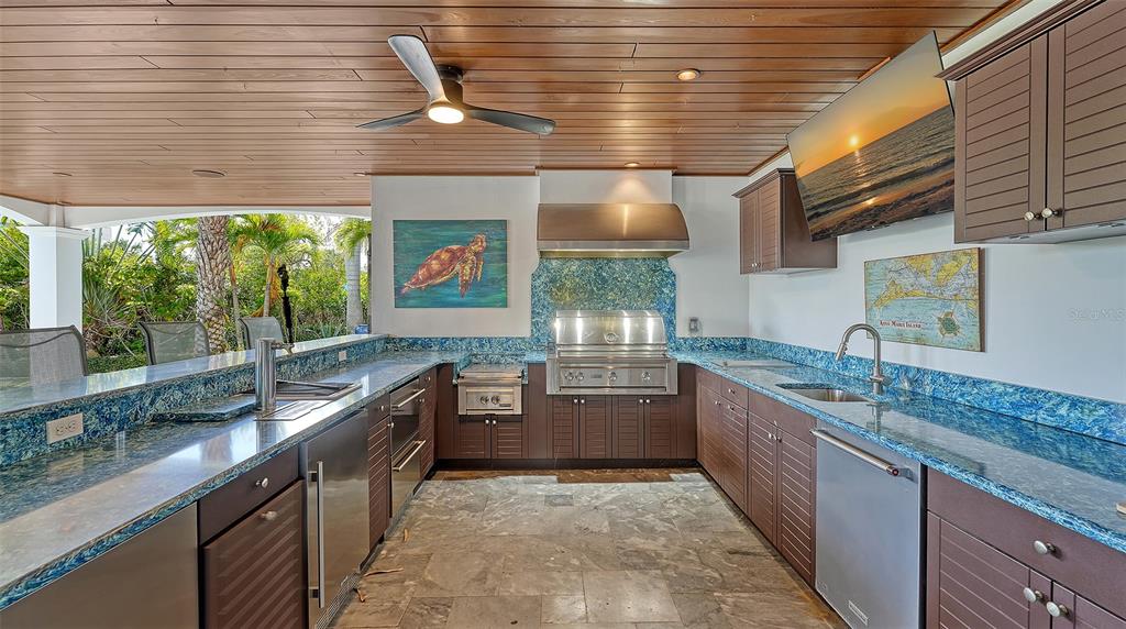 513 Villa Rosa Way Anna Maria, FL 34216 - Photo 52 of 57 a kitchen with stainless steel appliances granite countertop a sink and a wooden cabinets