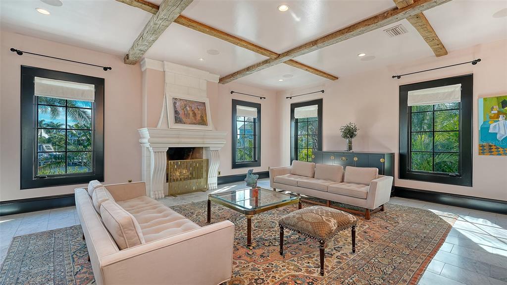 513 Villa Rosa Way Anna Maria, FL 34216 - Photo 6 of 57 a living room with furniture and a fireplace