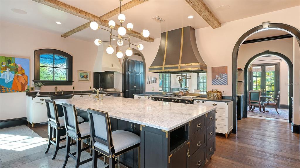 513 Villa Rosa Way Anna Maria, FL 34216 - Photo 7 of 57 a view of a dining room with furniture window and wooden floor