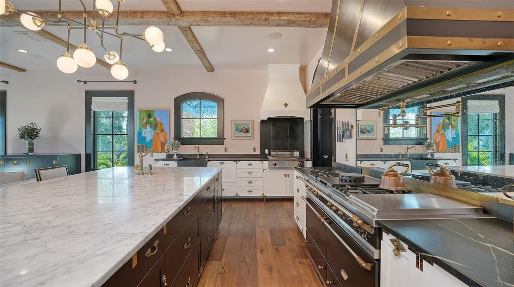 513 Villa Rosa Way Anna Maria, FL 34216 - Photo 8 of 57 a kitchen with lots of counter top space a sink and stainless steel appliances