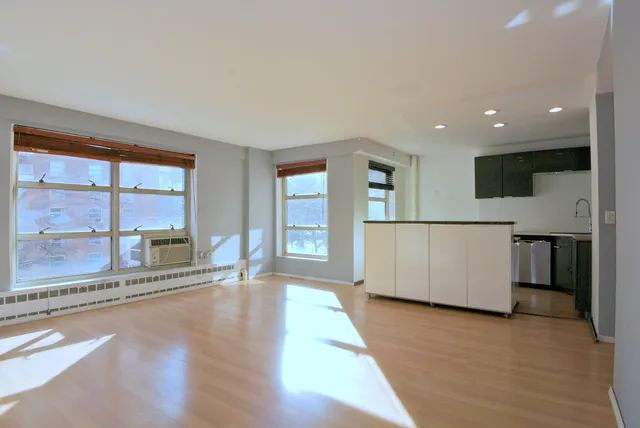 a spacious bedroom with a bed and a large window