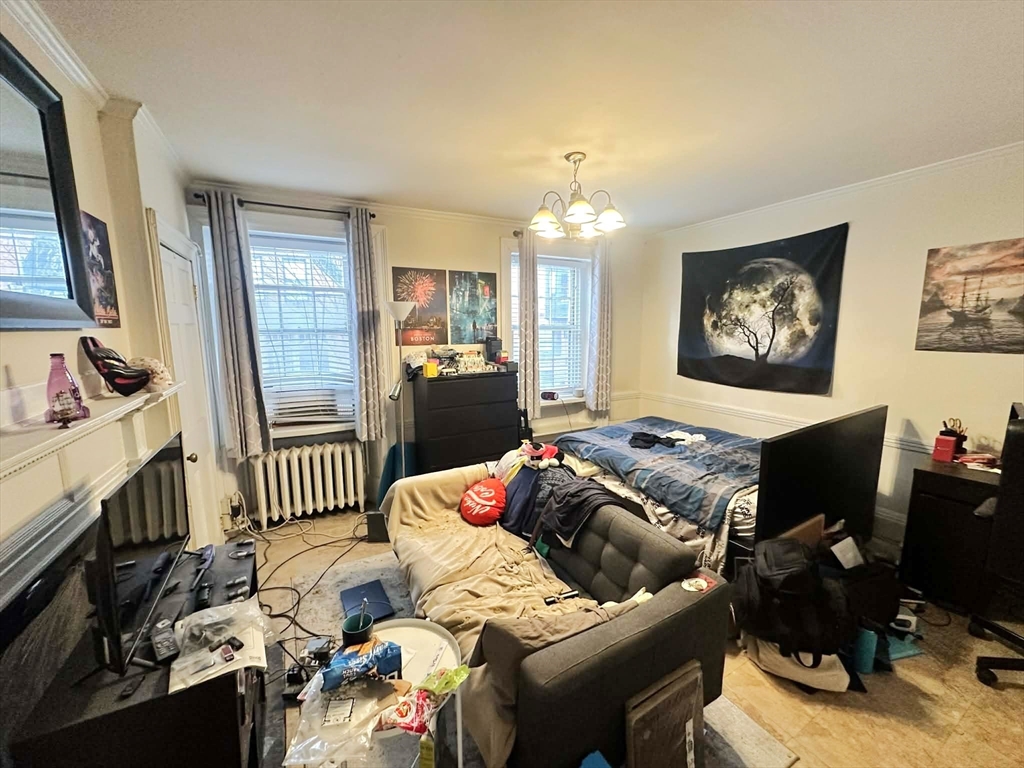 83 Charles Street, Unit 1 Boston, MA 02114 - Photo 3 of 11 a living room with furniture and a flat screen tv with wooden floor