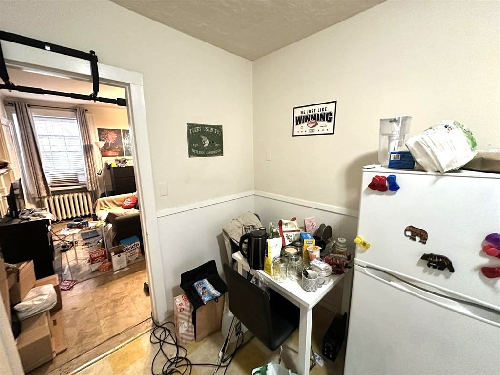 83 Charles Street, Unit 1 Boston, MA 02114 - Photo 5 of 11 a living room with furniture and a table
