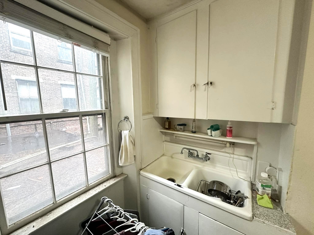 83 Charles Street, Unit 1 Boston, MA 02114 - Photo 8 of 11 a utility room with a window