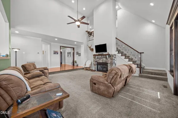 a living room with furniture a fireplace and a flat screen tv