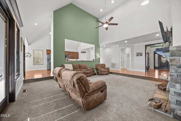 a living room with furniture and a ceiling fan