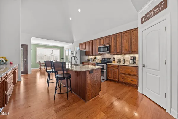 a kitchen with a table chairs refrigerator and cabinets