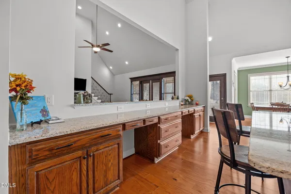 a large kitchen with stainless steel appliances a sink and cabinets