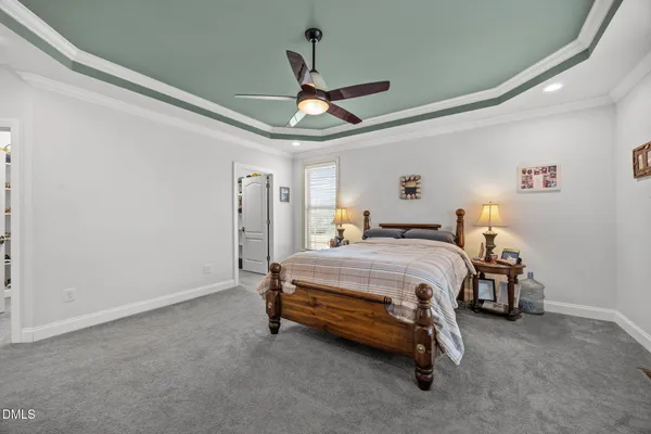 a bedroom with a bed and a chandelier