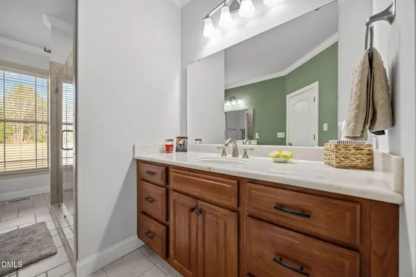 a bathroom with a double vanity sink and a mirror
