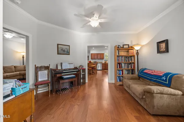 a living room with furniture and a wooden floor