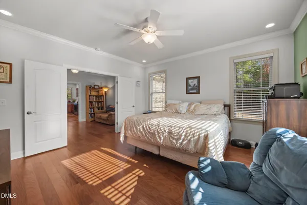 a spacious bedroom with a bed a window and a chandelier