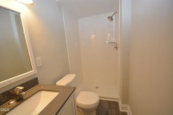 a bathroom with a toilet a sink and shower