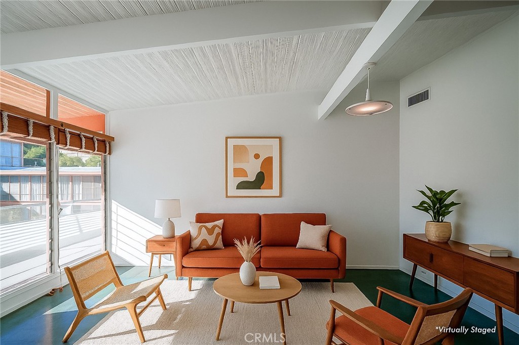 a living room with furniture and a potted plant