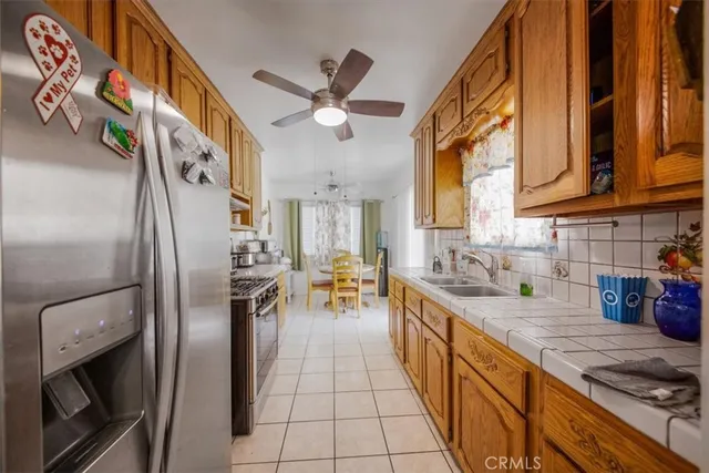 a kitchen with stainless steel appliances granite countertop a sink a stove and refrigerator