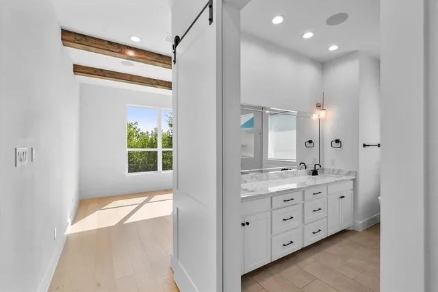 a bathroom with a double vanity sink mirror and shower