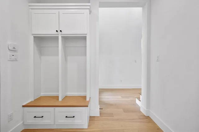 a bathroom with a granite countertop double vanity sink and a mirror