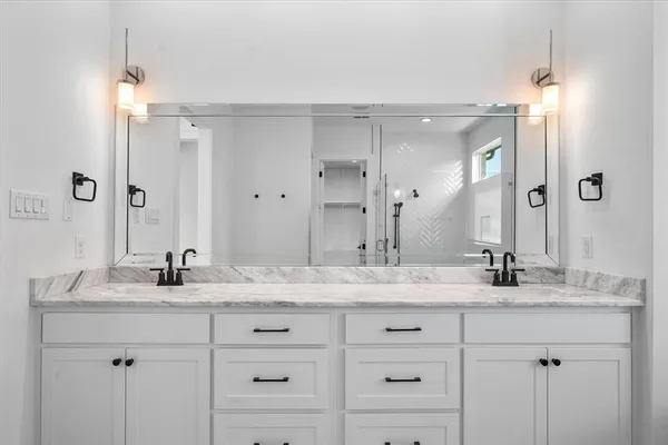 a kitchen with stainless steel appliances granite countertop white cabinets and window