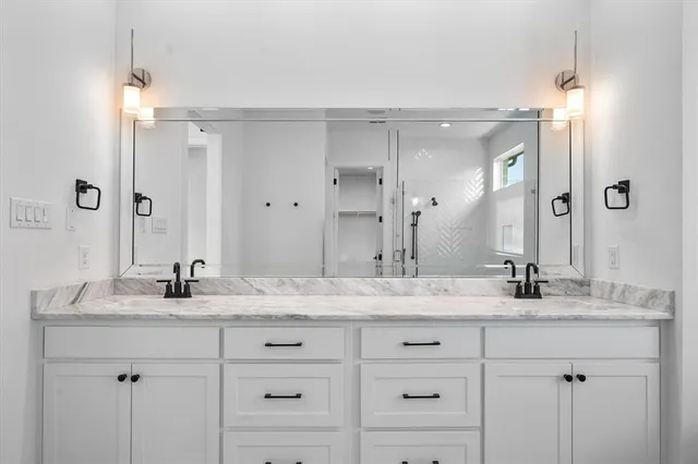 a kitchen with stainless steel appliances granite countertop white cabinets and window