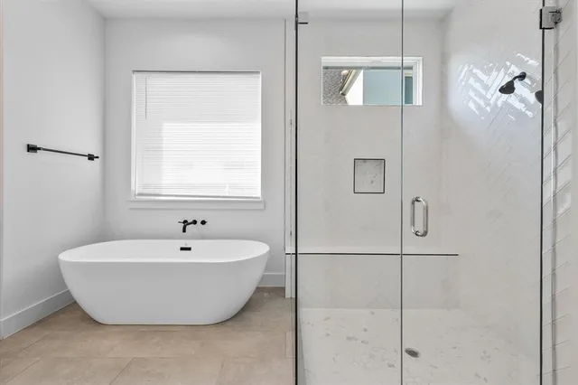 a white bath tub sitting next to a shower