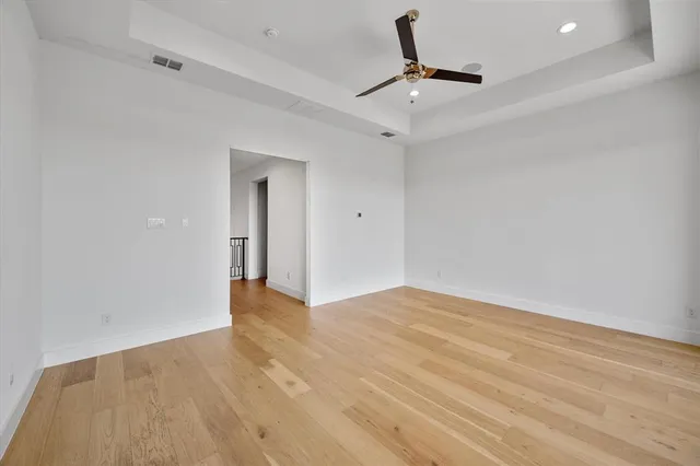 a bathroom with a granite countertop sink a toilet a mirror and shower