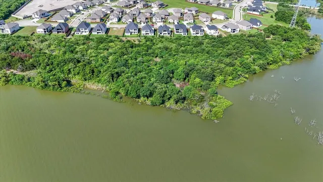 an aerial view of multiple houses with a yard