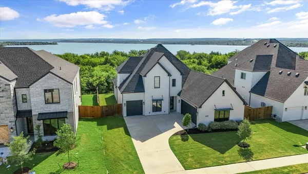 a aerial view of a house next to a yard
