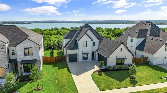 a aerial view of a house next to a yard