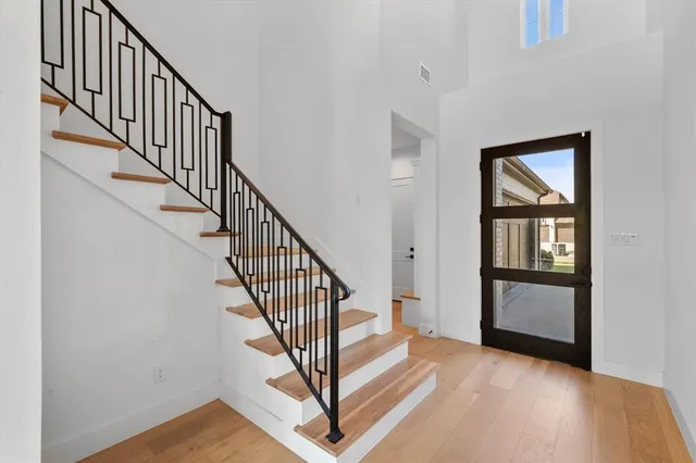 a view of an entryway with wooden floor and door