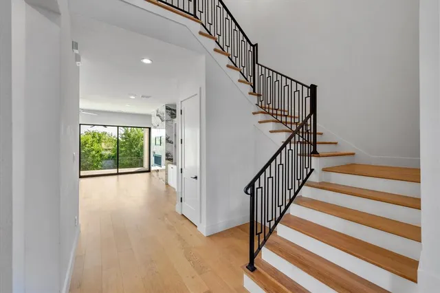 a view of staircase with wooden floor and a window
