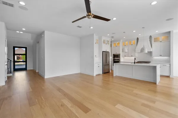 a view of kitchen with granite countertop cabinets and refrigerator