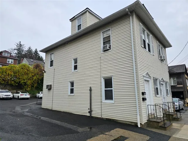 a view of a white house with a white roof