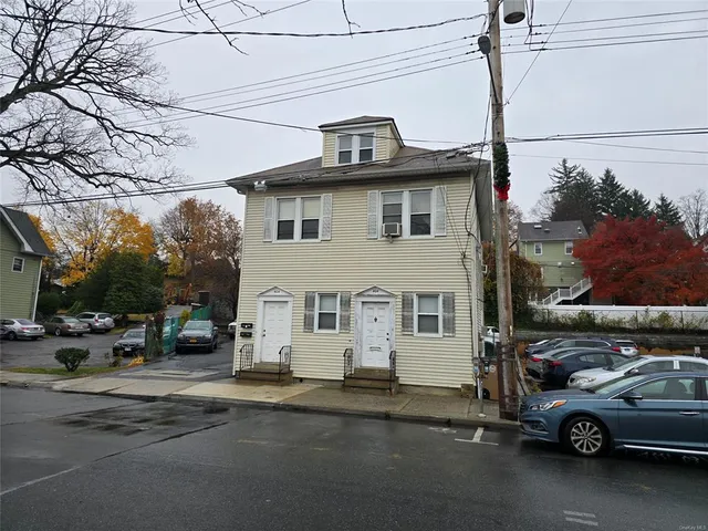 a view of a car parked in front of a house