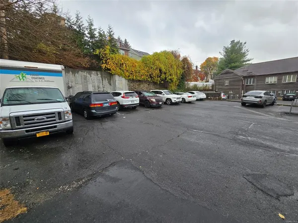 a view of street with parked cars