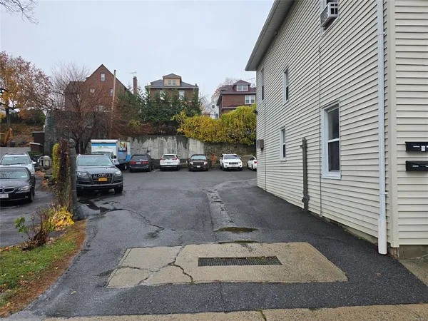 a view of a cars park in front of a house