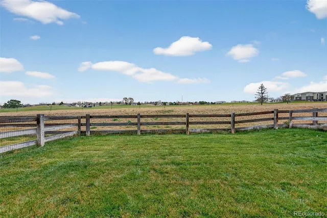 a view of a street with houses in the background