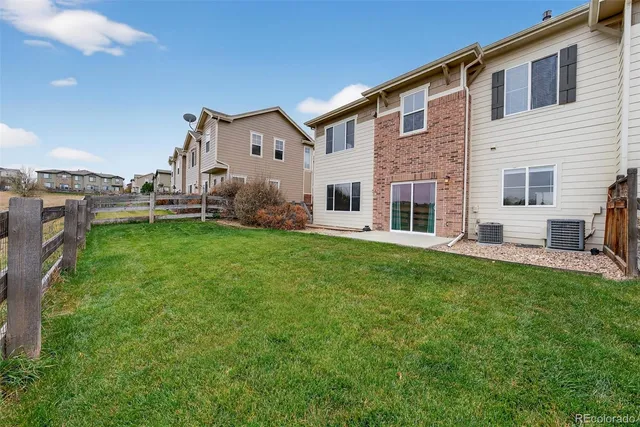 a front view of a house with a yard and porch