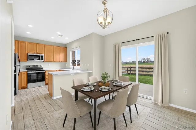 a kitchen with a table chairs stove and microwave