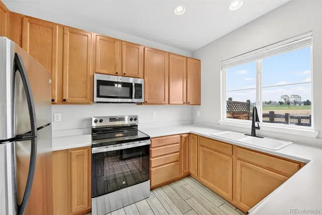 a kitchen with a sink stove top oven and cabinets