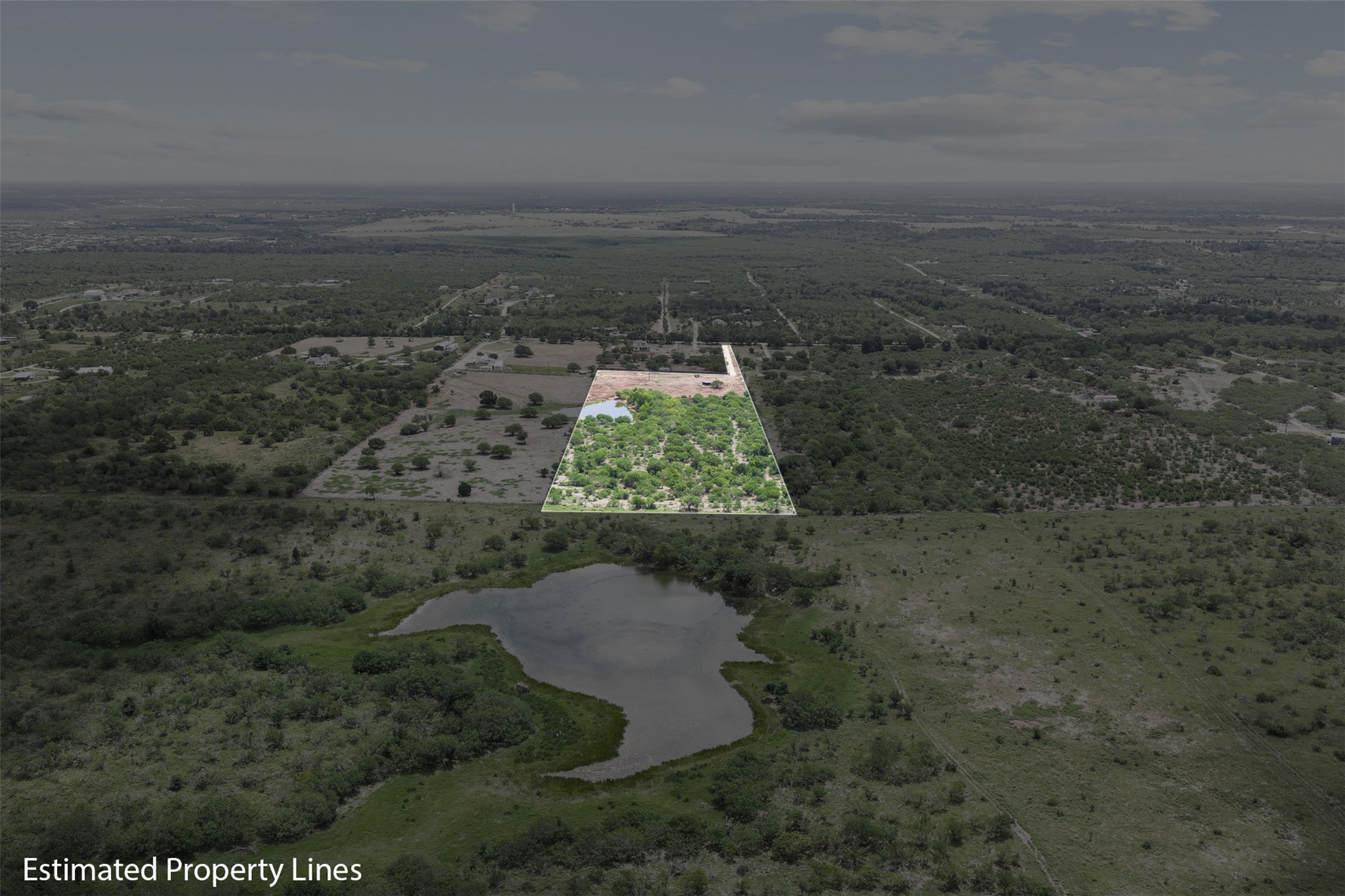 3315 Dry Creek Road Lockhart, TX 78644 - Photo 7 of 26 A verdant, sprawling acreage featuring a natural pond, ready for development or private retreat.