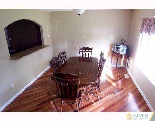 27 Dover Road Colonia, NJ 07067 - Photo 3 of 10 a view of a dining room with furniture and wooden floor