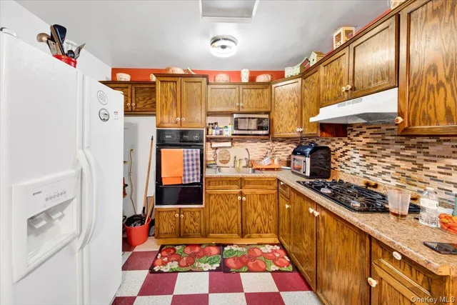 a kitchen with stainless steel appliances granite countertop a refrigerator and a stove