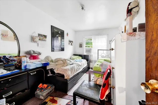 a living room with furniture and a baby crib