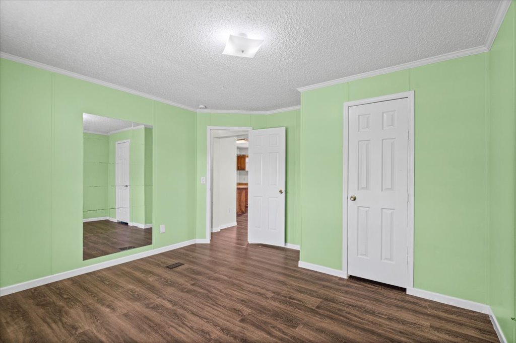 13501 Nutty Brown Road, Unit B Austin, TX 78737 - Photo 17 of 29 The open-plan living area features rich wood flooring and a luminous ceiling light fixture.