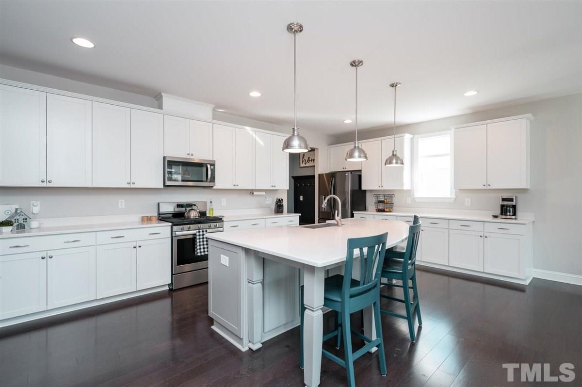 7056 Rex Road Holly Springs, NC 27540 - Photo 4 of 28 This kitchen is stunning! Open to the living room, this room is certainly the heart of the home